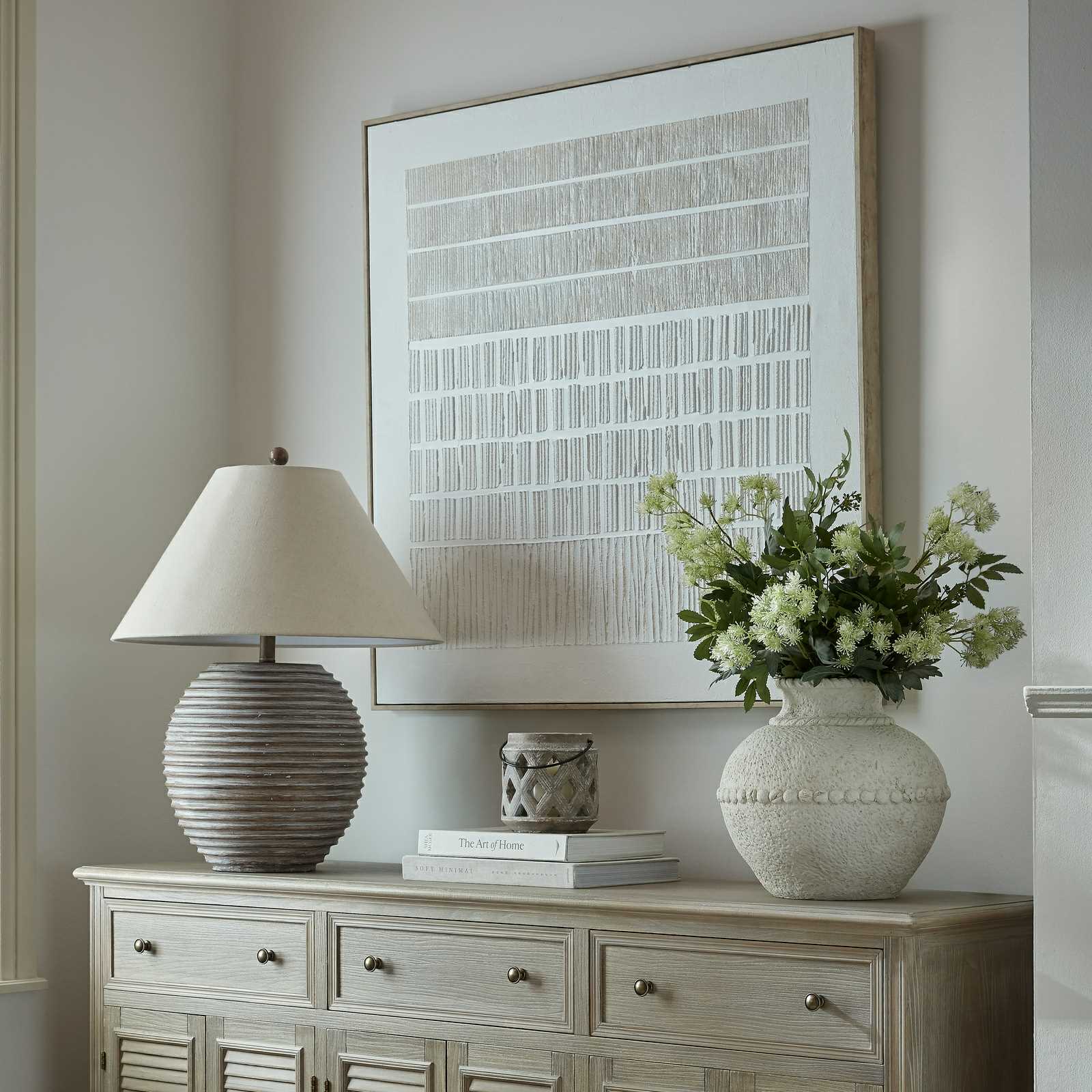 Sola textured line canvas in a pale wood frame above a sideboard
